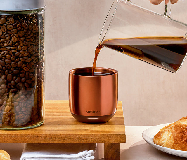 Coffee being poured into an espresso cup.